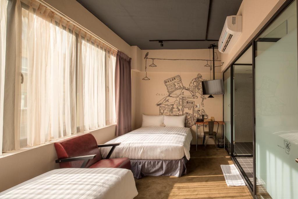 a hotel room with two beds and a window at Cho Hotel in Taipei
