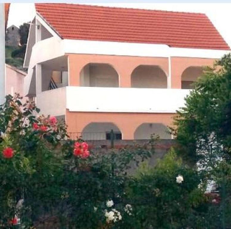 a house with a red roof and some trees at Apartment in Tribunj with balcony, air conditioning, WiFi 5038-3 in Tribunj