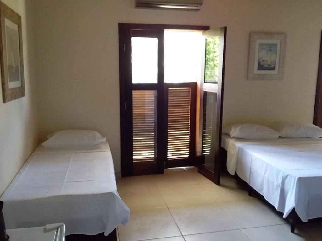 Postel nebo postele na pokoji v ubytování Residencial Seestern - Suítes