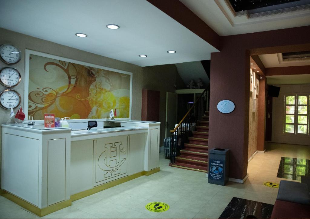 a room with a kitchen with a sink and a staircase at Park Çağlayan Hotel in Istanbul