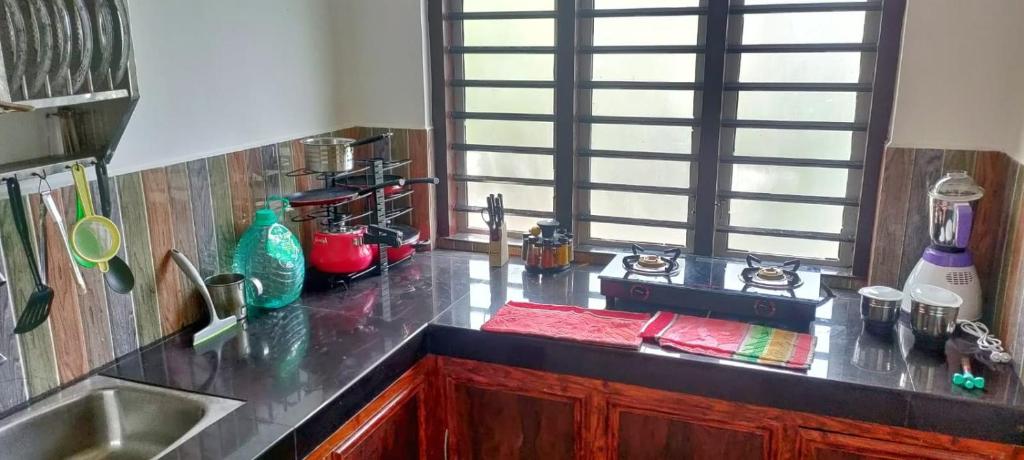 a kitchen with a sink and a counter top at Wayanad Days in Mananthavady