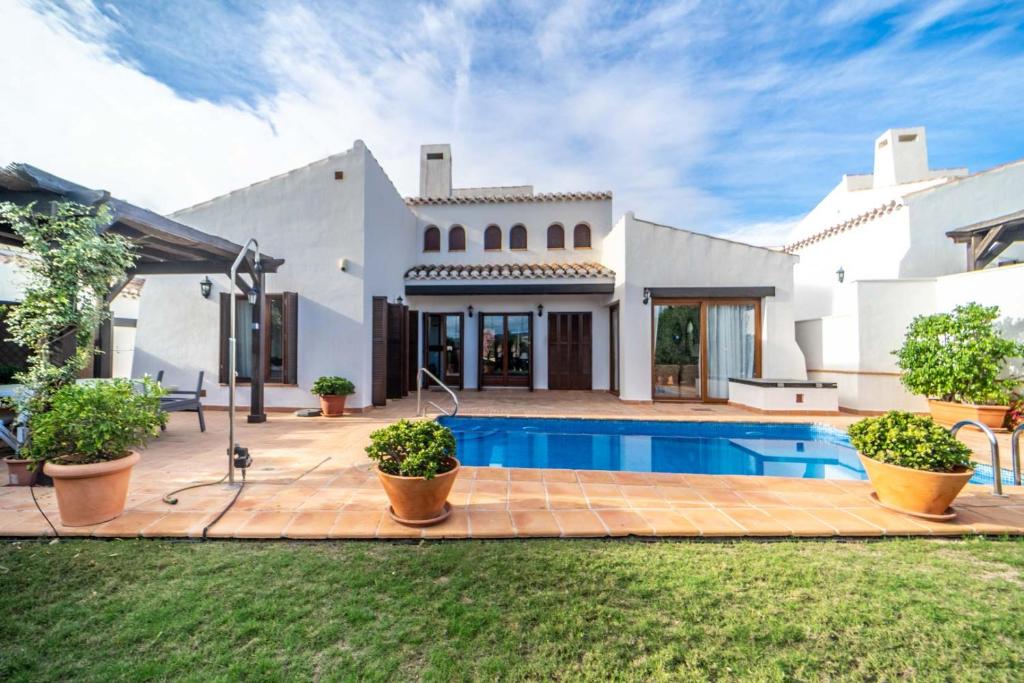 a house with a swimming pool in the yard at Stunning detached Villa in El Valle Golf Resort - ZO22EV in Murcia