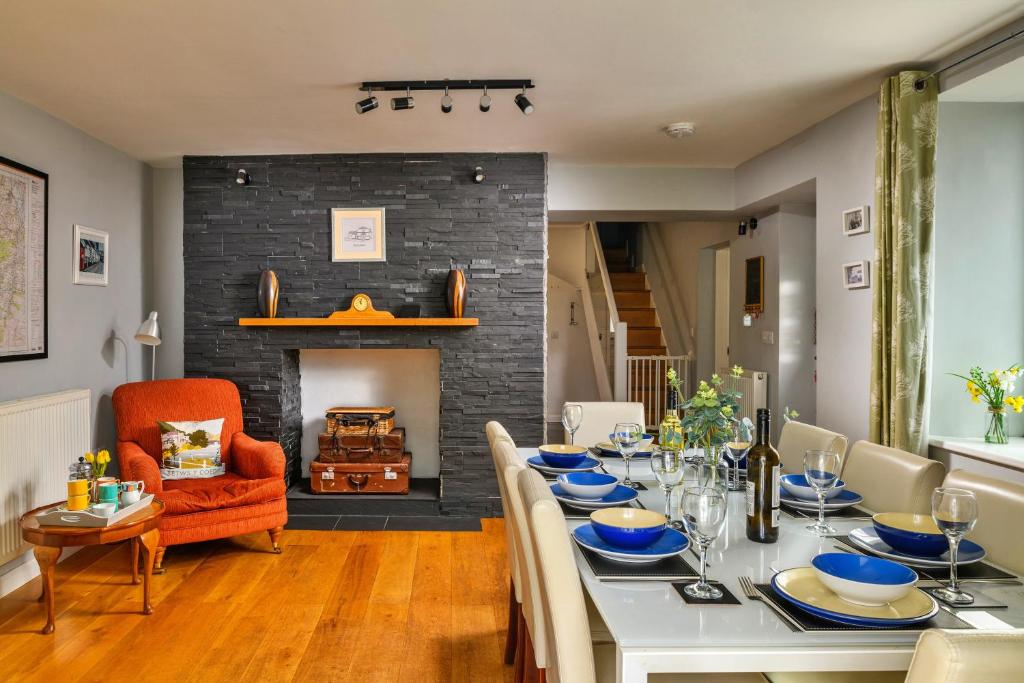 a dining room with a table and a fireplace at Finest Retreats - Bodlawen Holiday House - Edge of Snowdonia in Cerrig-y-Druidion