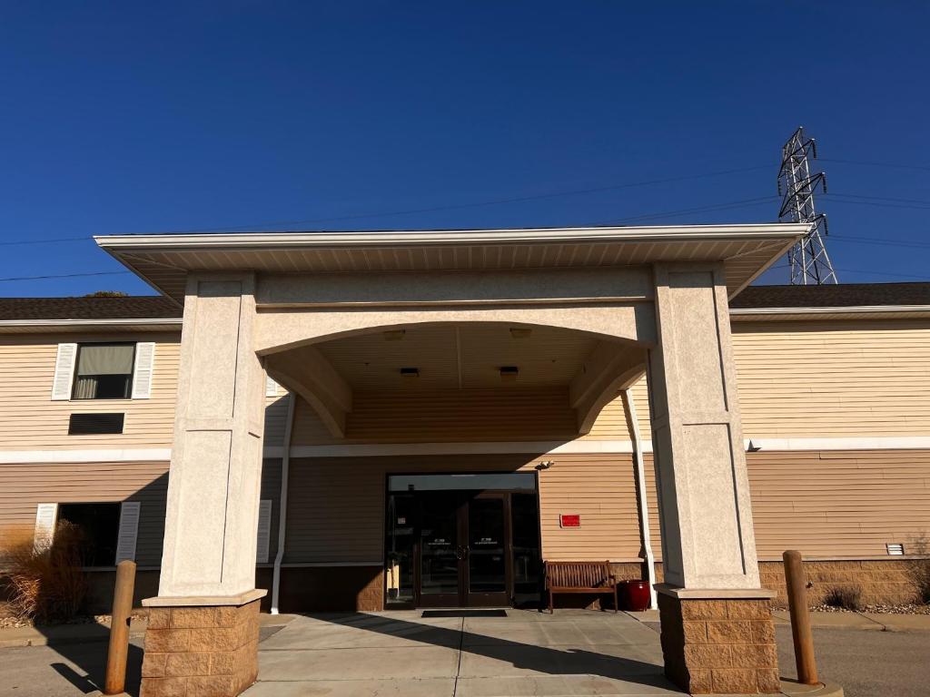 a building with a large entrance to a garage at Ambridge Inn in Ambridge