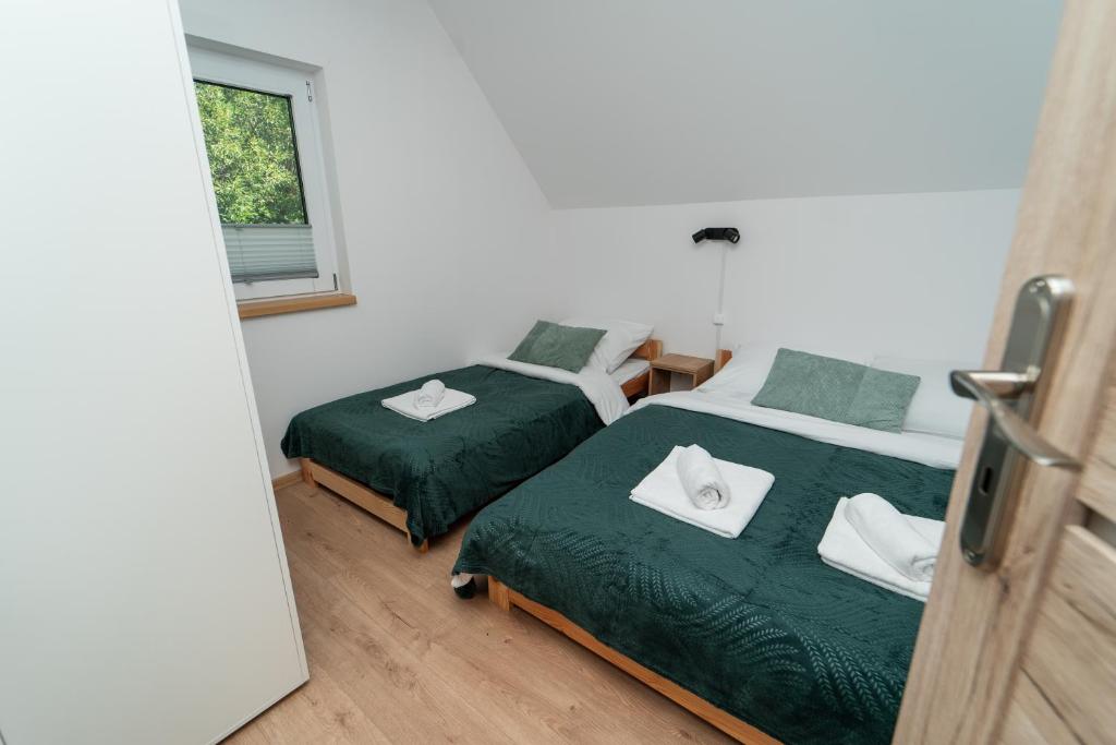 Postel nebo postele na pokoji v ubytování ApartView House Dolina Partecznik by Rent like home