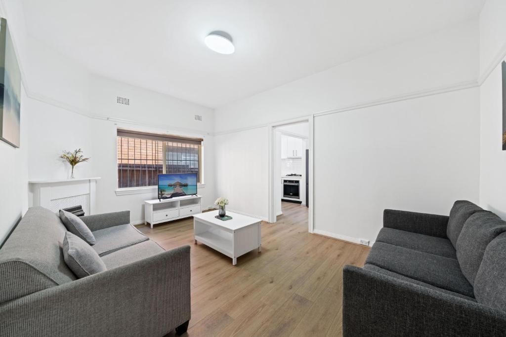 a living room with two couches and a tv at Burwood New 2 Bedroom 2 Bath Apt Free Parking in Sydney