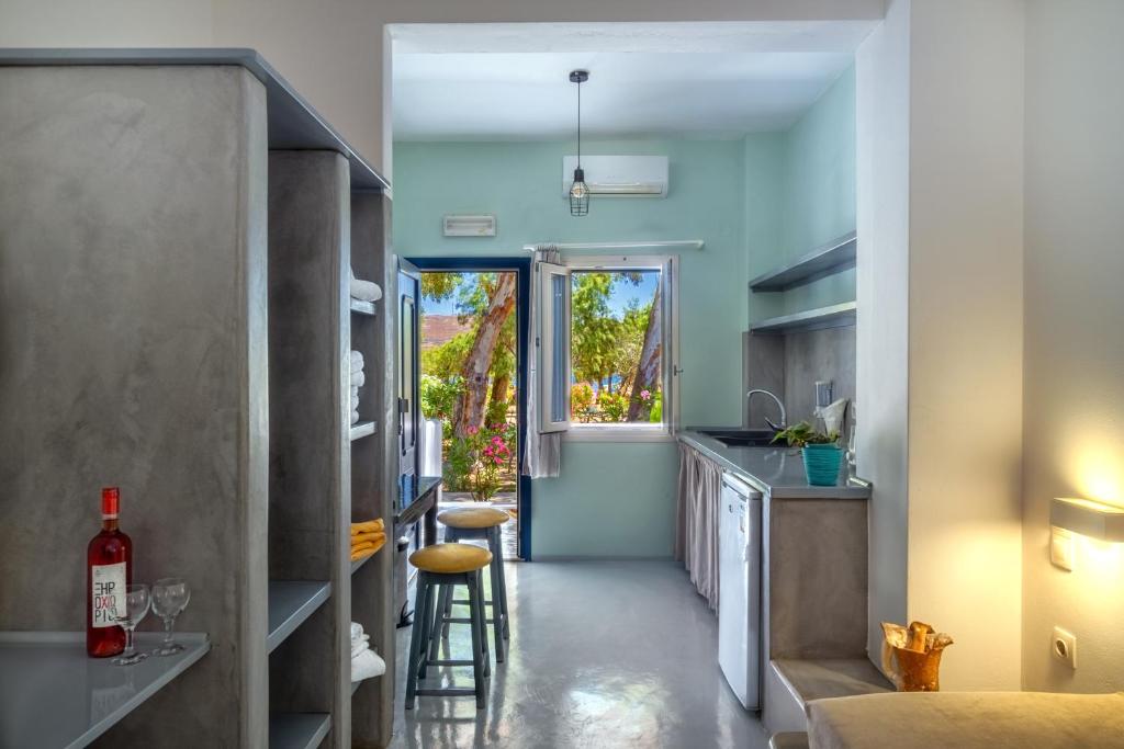a small kitchen with a sink and a counter at Coralli Seaside Resort in Livadakia