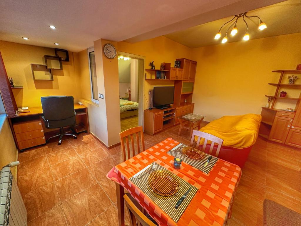 a living room with a dining table and a bedroom at 20 OFF Sun Dance Apartment in Sofia