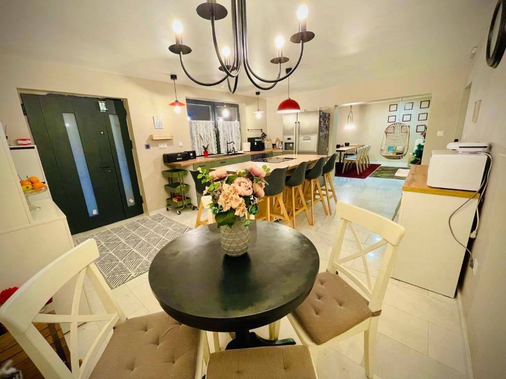 a kitchen with a table with a vase of flowers on it at Vila Montana Valiug in Văliug