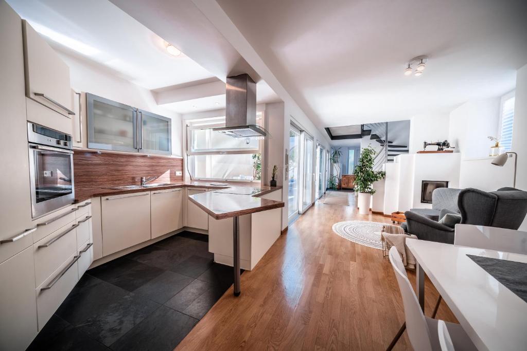 a kitchen with white cabinets and a counter top at Ferienhaus - Das Goldgassl in Appiano sulla Strada del Vino