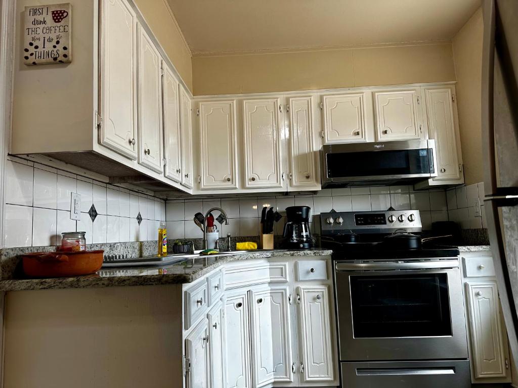 a kitchen with white cabinets and a stove top oven at The Rustic @ Paseo de Encinal Drive in Eagle Pass