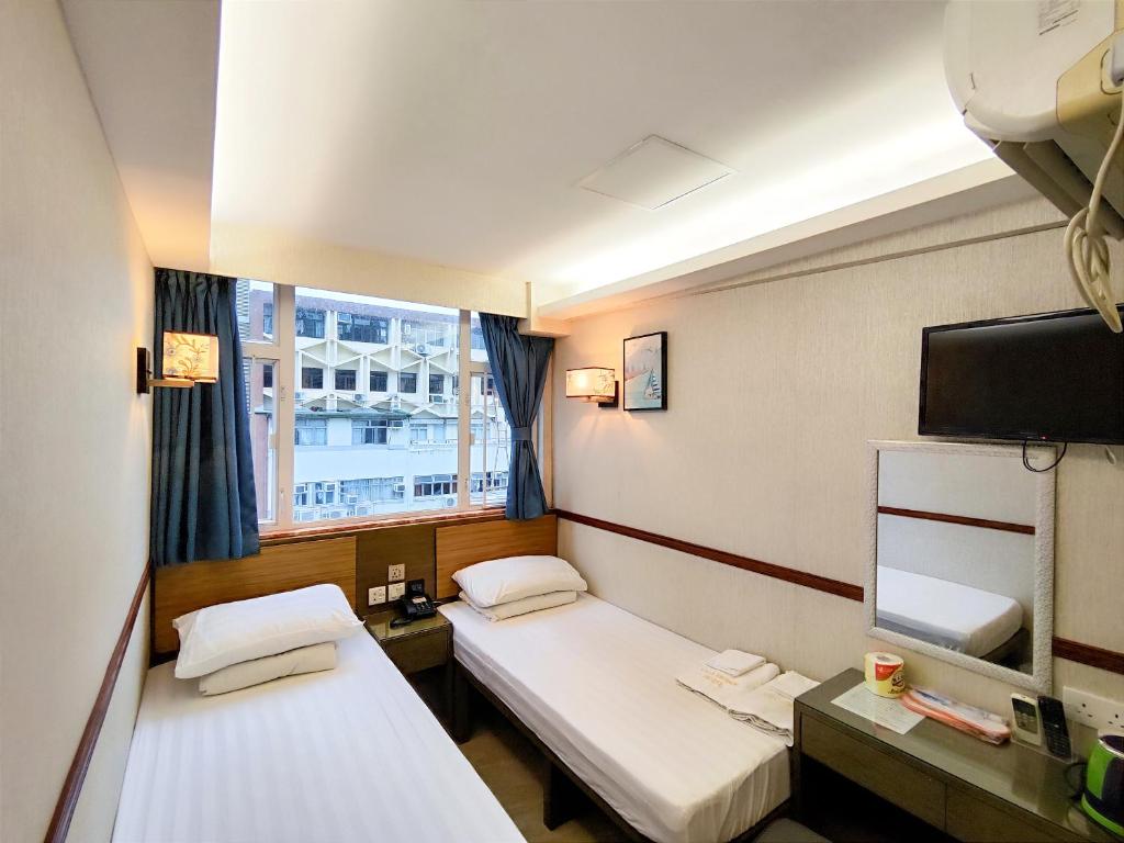 Postel nebo postele na pokoji v ubytování Celltronik Hostel 先創旅店