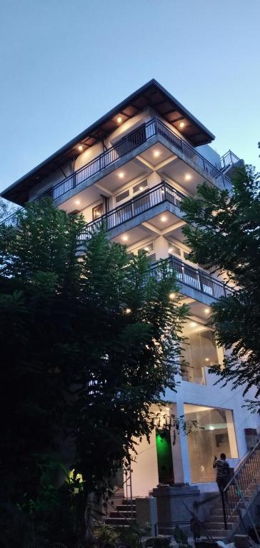 a large building with lights on top of it at Lanka Villas Holiday Resort in Kandy
