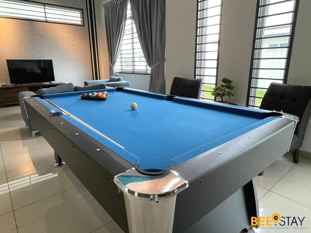 a pool table with a ball on top of it at Desaru Arcadia Villa with Pool Table, Outdoor BBQ, Indoor Steamboat by Beestay in Kangkar Chemaran