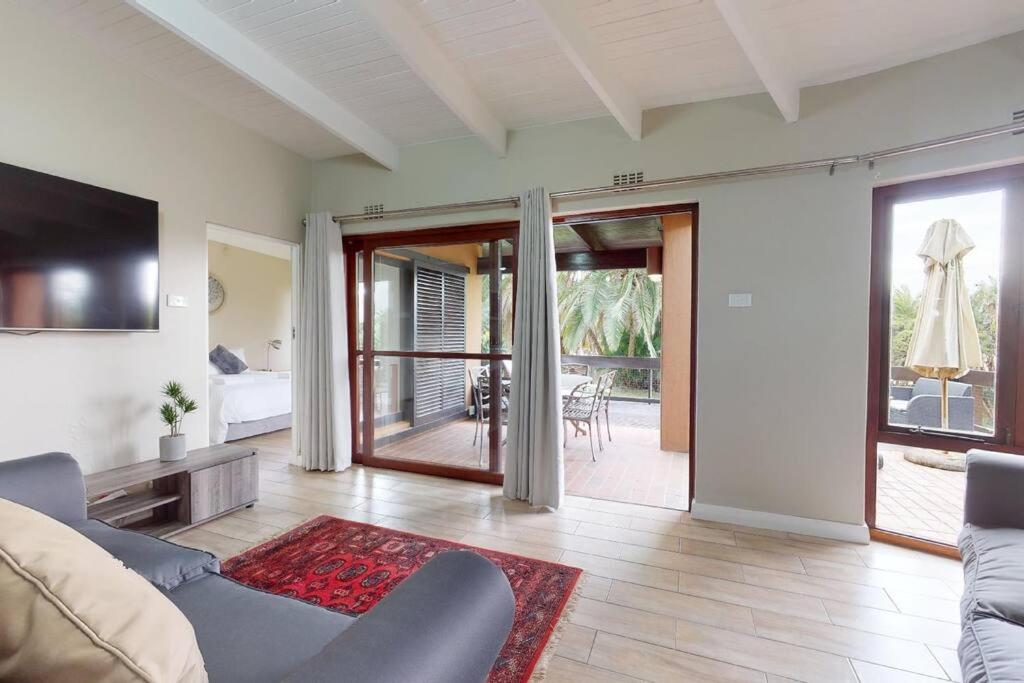 a living room with a couch and a tv at San Lameer 2820 by Top Destinations Rentals in Southbroom