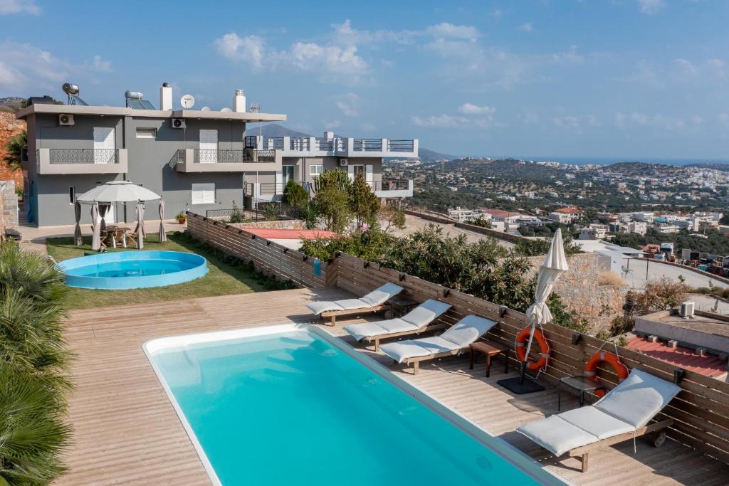 a villa with a swimming pool and a house at Amina villa in Agios Nikolaos