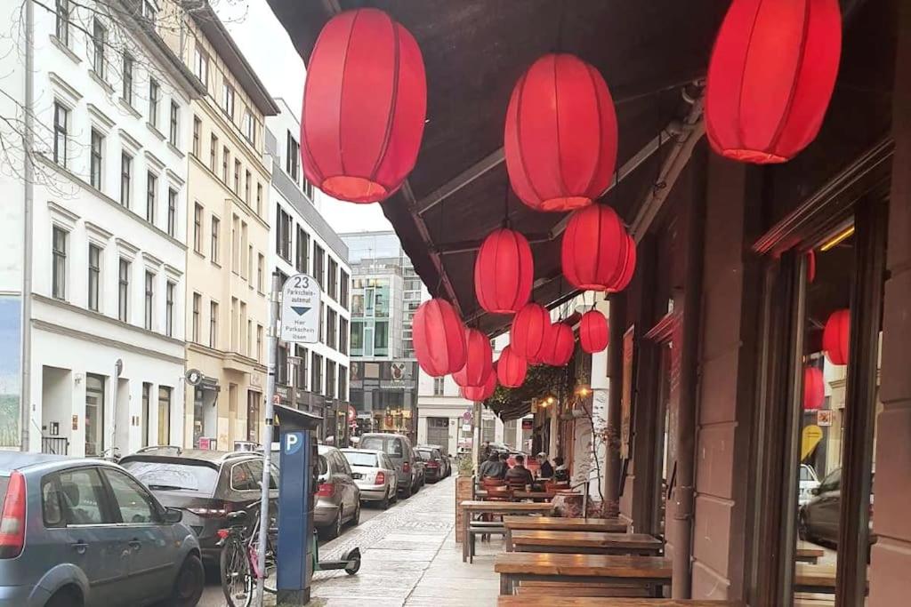 a row of red lanterns hanging from a building at Lovely apartament in Mitte Berlin 2021 in Berlin