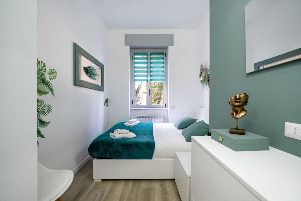 a white bedroom with a bed and a sink at [Linate Airport] Elegant Suite,Tram 1 minute away in Milan