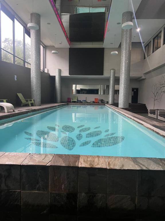 a large swimming pool in a building at Umhlanga Ridge One Bedroom Self-Catering apartment in Durban