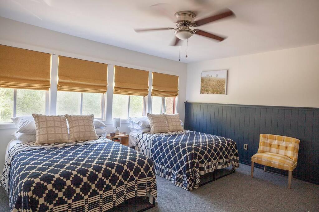 a bedroom with two beds and a ceiling fan at 1 Mile to Hunter Mt! Cozy 3 Bedroom in Hunter