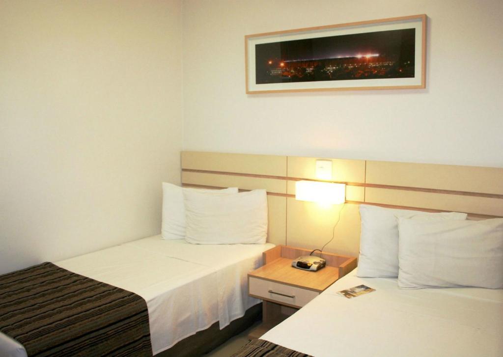 Postel nebo postele na pokoji v ubytování Pampulha Lieu Hotel