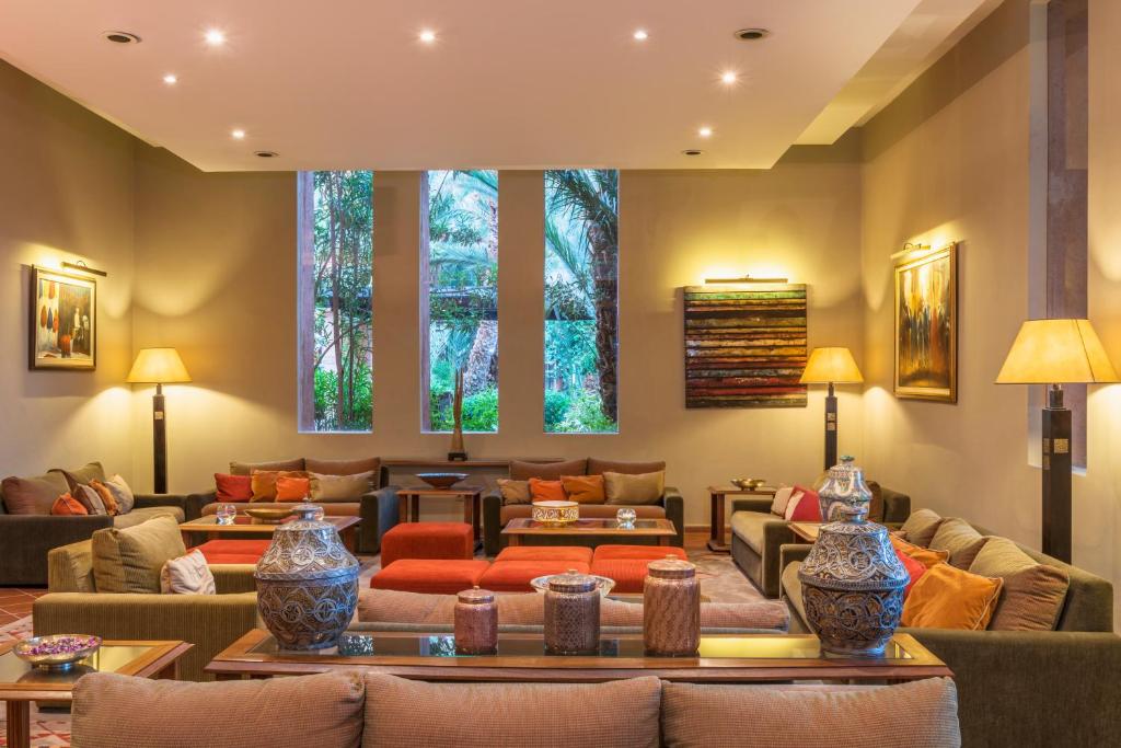 a living room with couches and tables at Berbère Palace in Ouarzazate