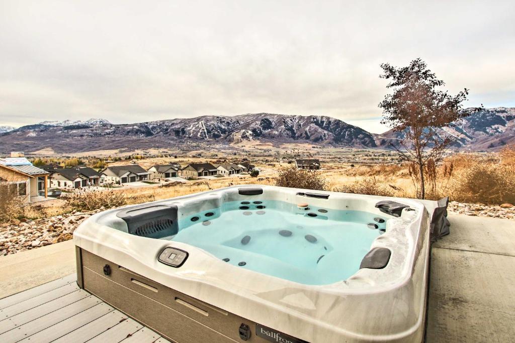 a hot tub on a deck with mountains in the background at Eden Home with Stunning View about 6 Mi to Skiing! in Eden