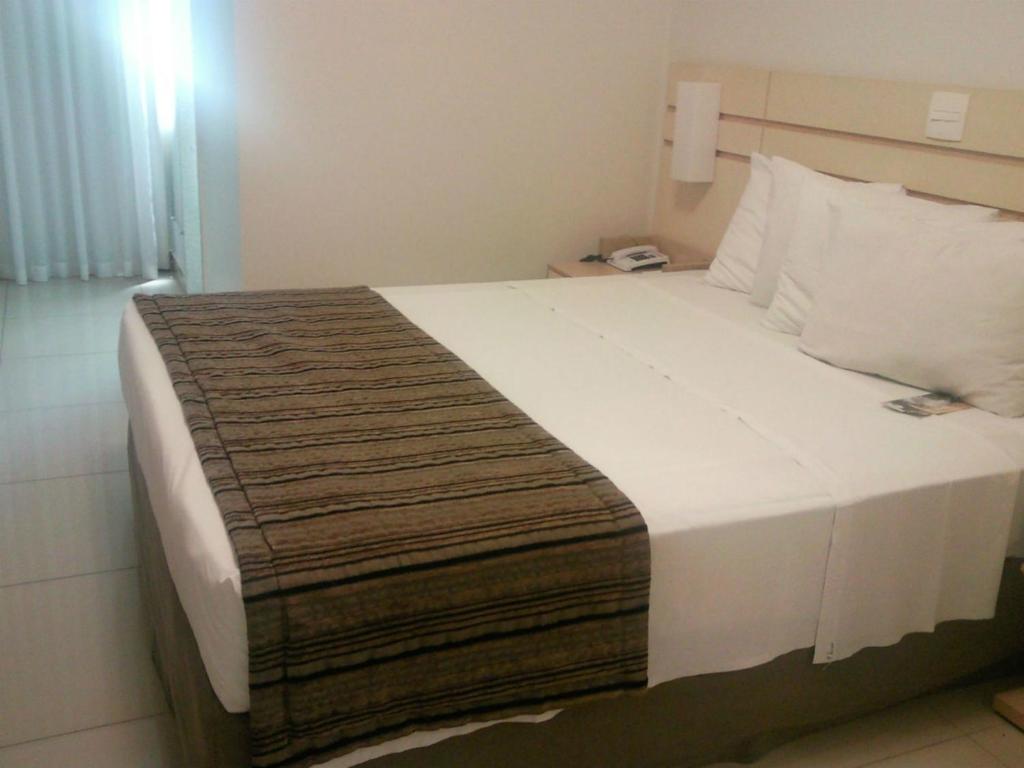 Postel nebo postele na pokoji v ubytování Pampulha Lieu Hotel