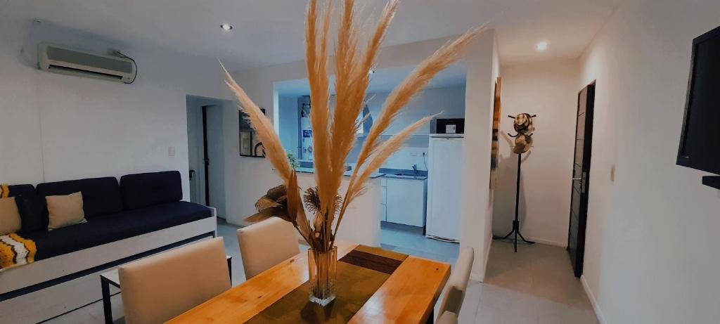 a living room with a table with a vase on it at Departamento Godoy Cruz Mendoza in Godoy Cruz