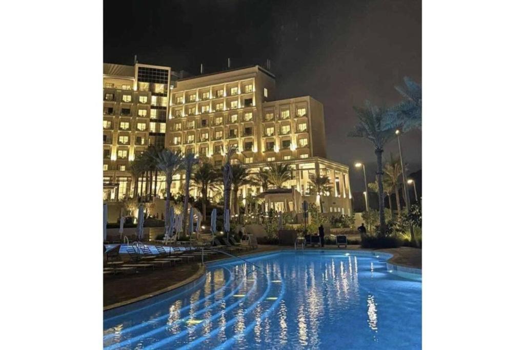 a large building with a fountain in front of it at Address Fujairah beach and resort Residence in Fujairah