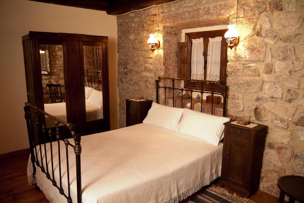 una camera con letto e parete in pietra di La Breval ad Alles