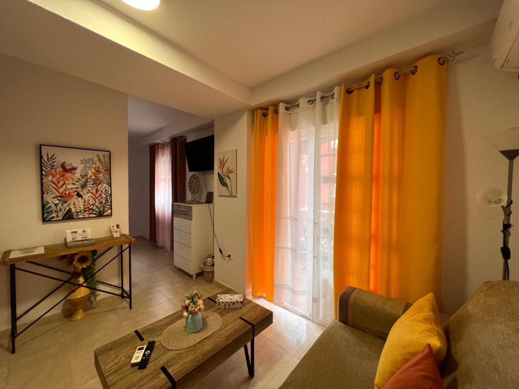a living room with a couch and a table at Estudios Costavigía Mazagón by Ramona in Mazagón