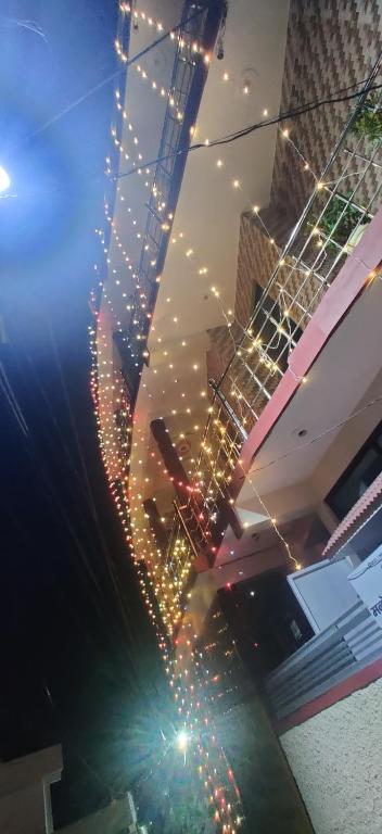 a string of lights on top of a building at Athalia guesthouse in Rishīkesh