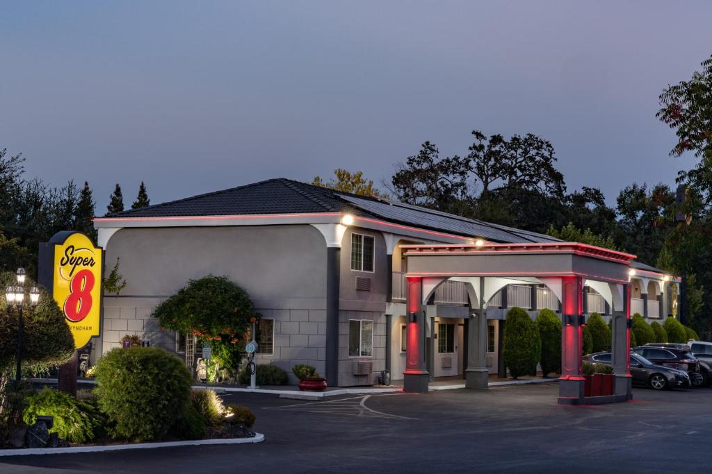 a hotel with a gas station in a parking lot at Super 8 by Wyndham Ukiah in Ukiah