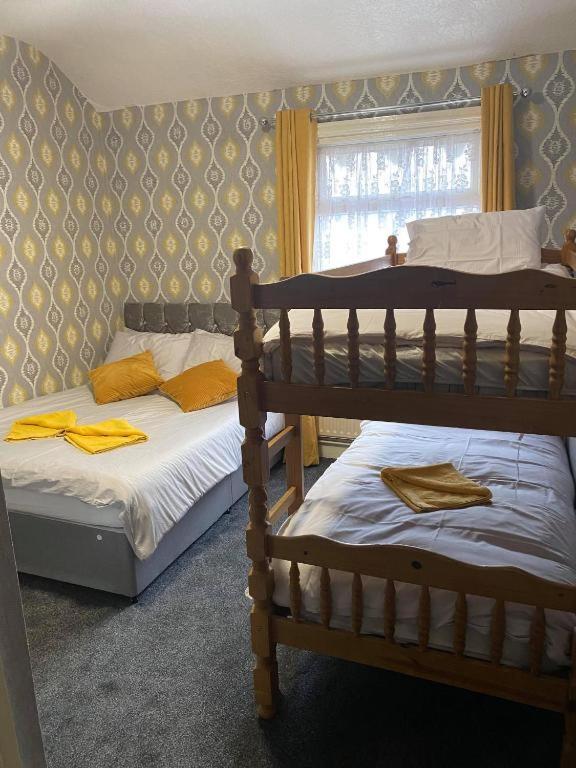 a bedroom with two bunk beds and a window at JEANNE in Blackpool