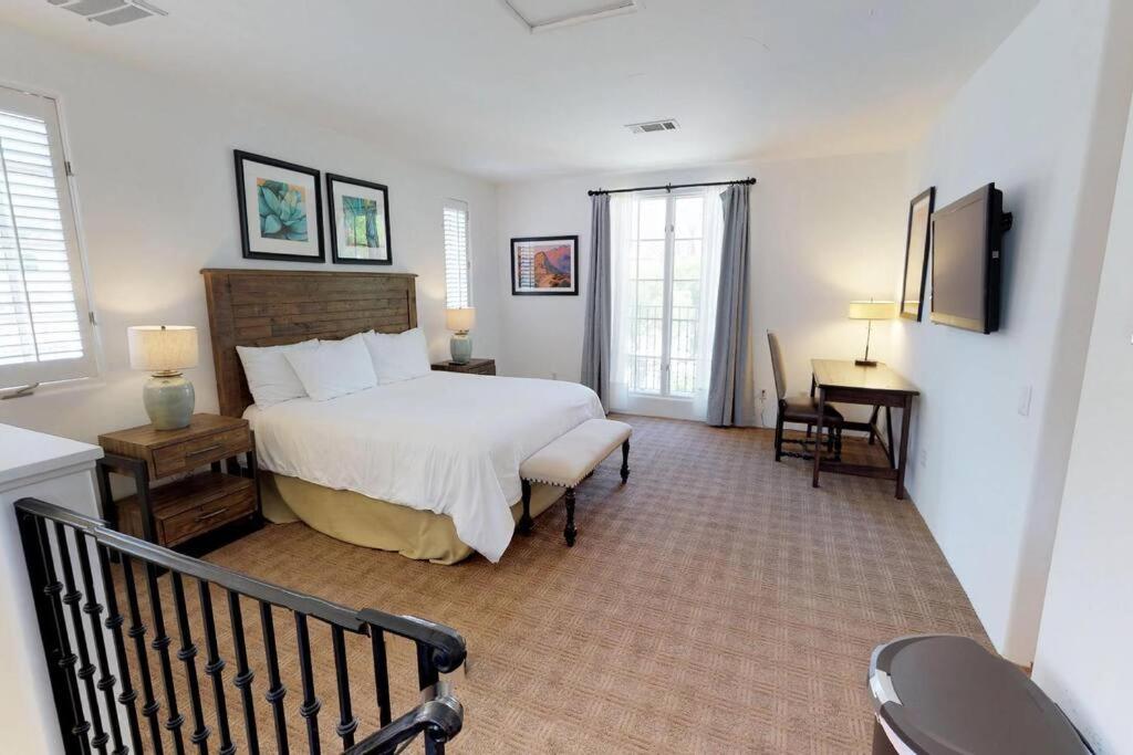 a bedroom with a bed and a desk in a room at SV006 Secluded Spa Villa Studio at LQ Resort in La Quinta
