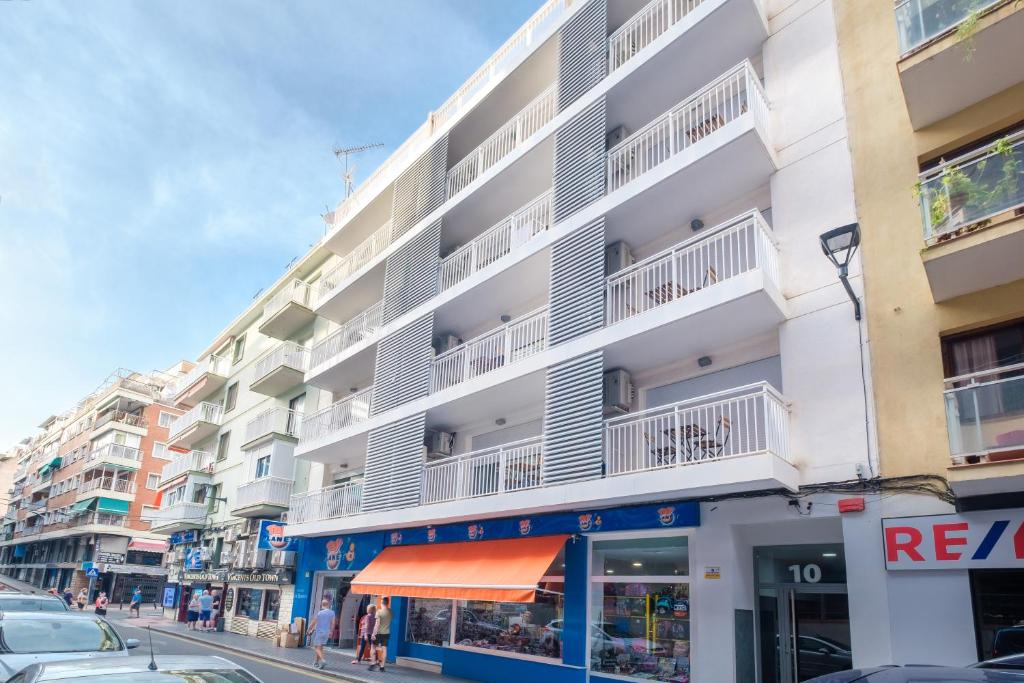 an apartment building with white balconies on a street at Apartamentos La Rosita Old Town B-21 in Benidorm