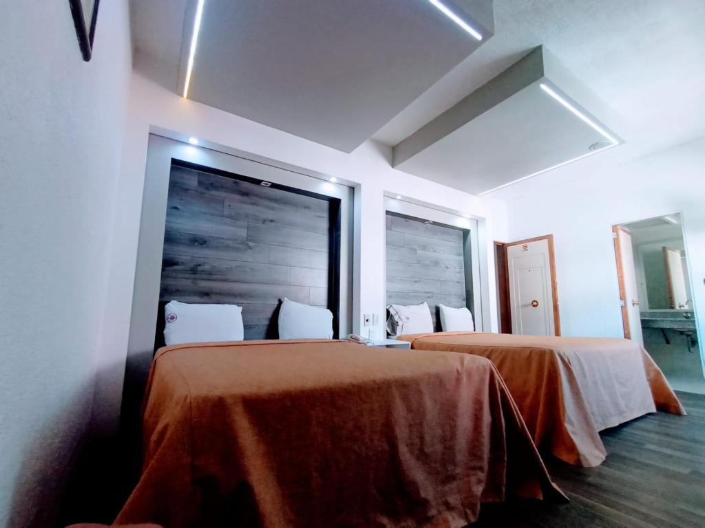 Postel nebo postele na pokoji v ubytování Hotel Mina