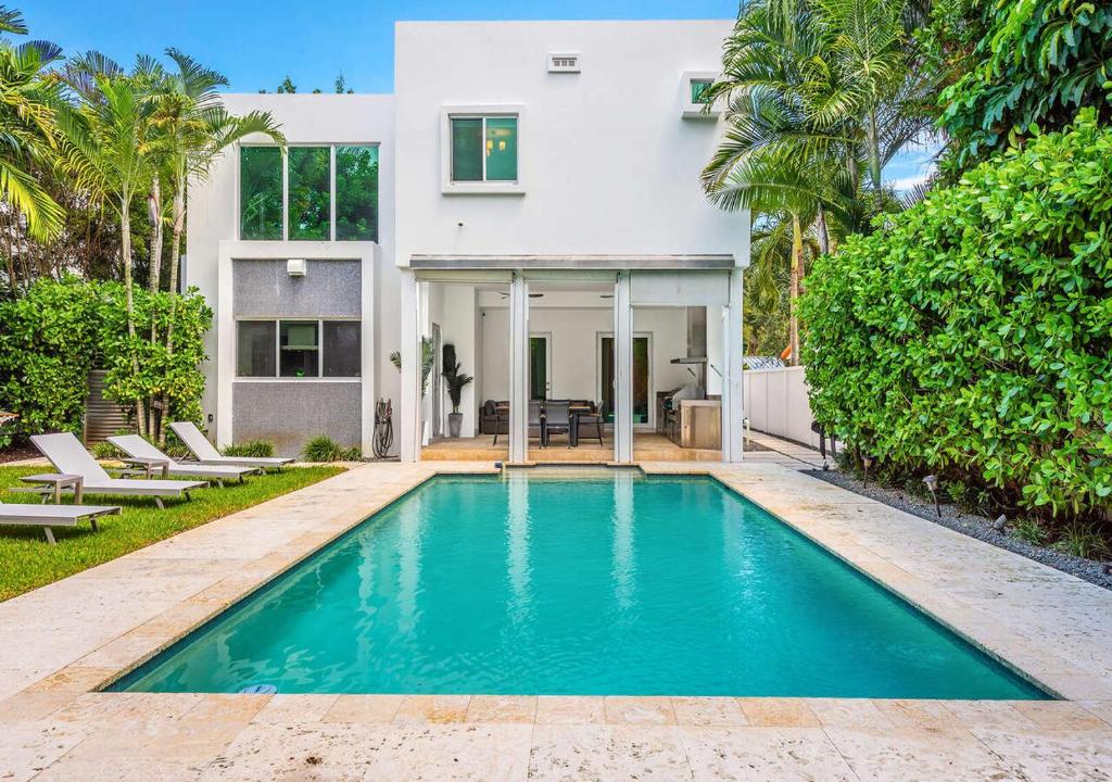a swimming pool in front of a house at Exotic 5 Bedroom Villa In South Miami in Miami