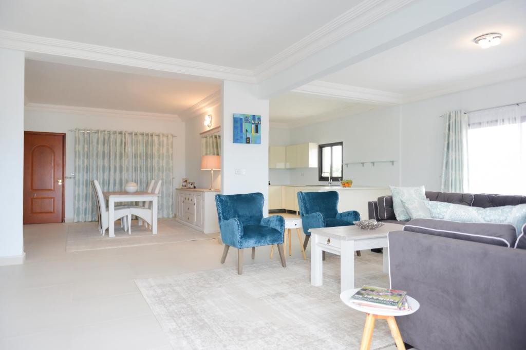 a living room with a couch and chairs and a table at Atlantic Luxury Apartments in Bakau
