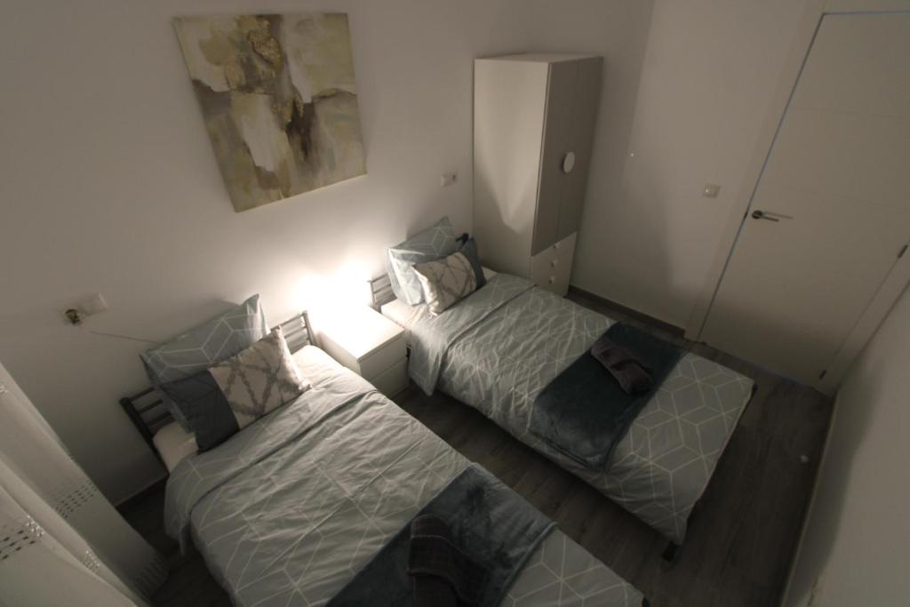 Postel nebo postele na pokoji v ubytování San Rafael Apartment Los Boliches