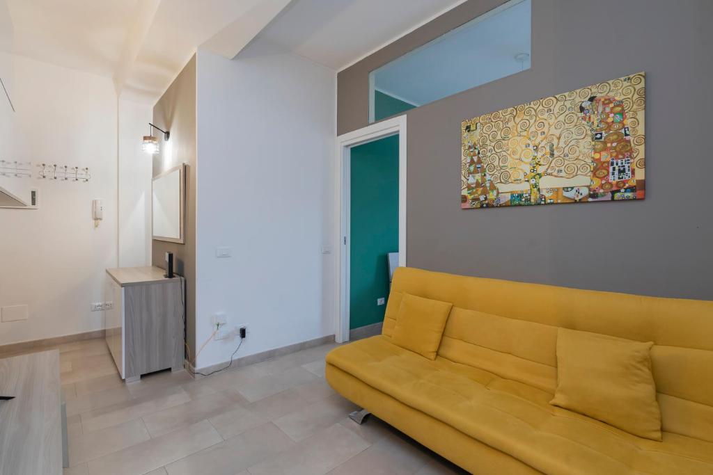 a living room with a couch and a painting on the wall at [Luxury apartment near Navigli] Carlo D'adda 29 in Milan