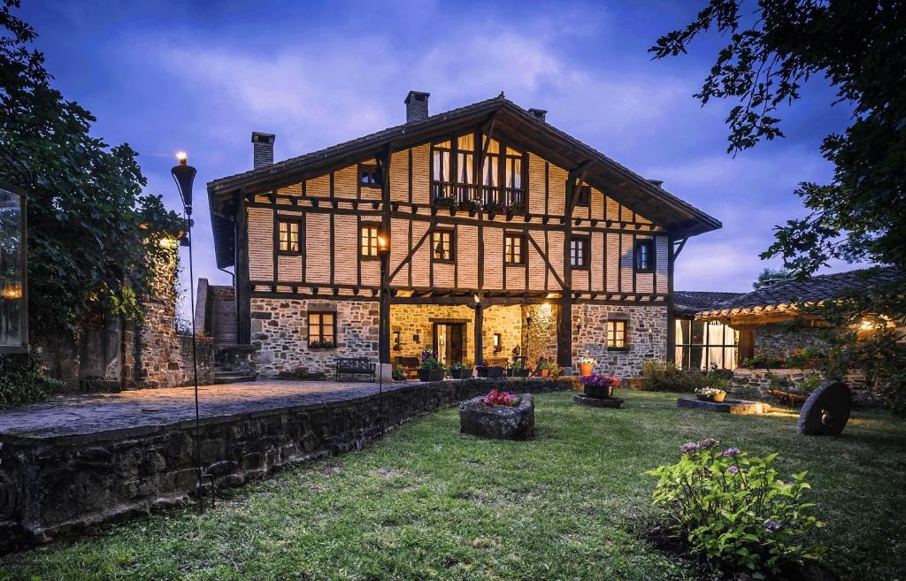 a large house with a stone wall at Caserio Iruaritz in Amurrio