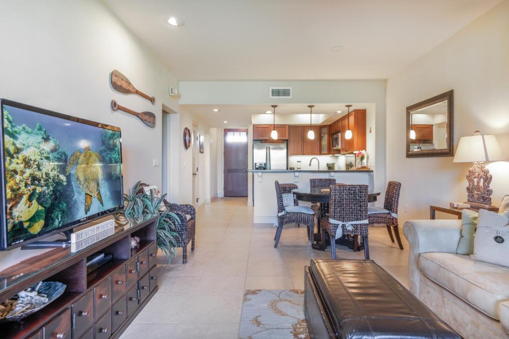 a living room with a large flat screen tv at Hali'i Kai 3B in Waikoloa