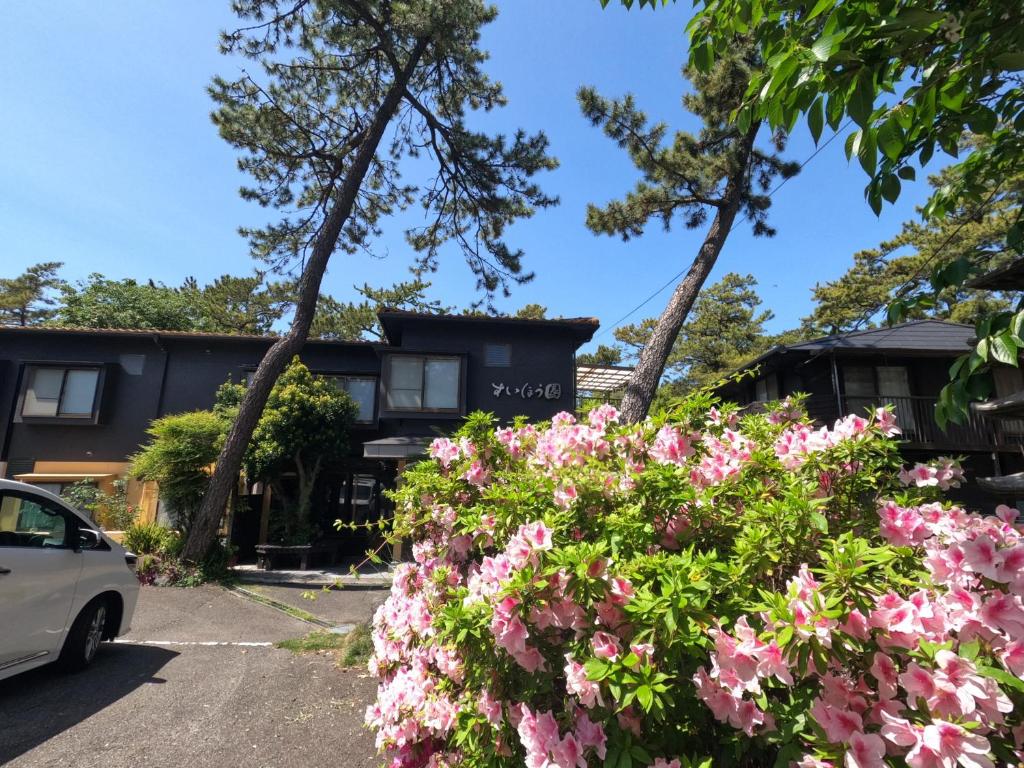 a house with pink flowers in front of it at SUIHOUEN in Numazu