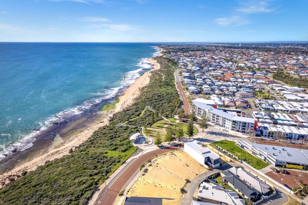 an aerial view of a beach and the ocean at Halls Head Haven in Mandurah