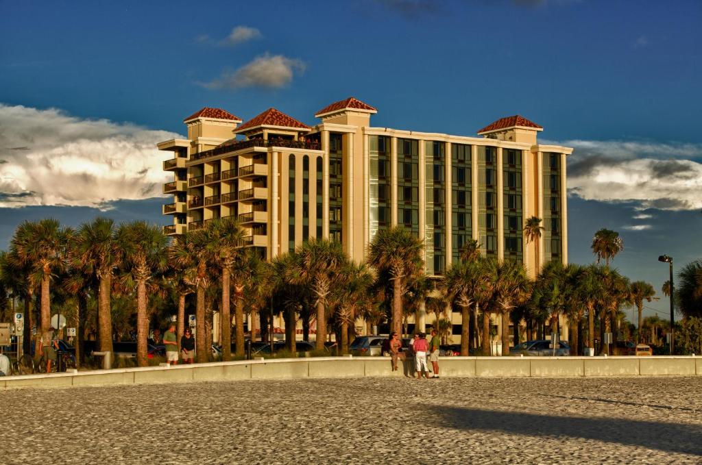 a large building with palm trees in front of it at Pier House 60 Clearwater Beach Marina Hotel in Clearwater Beach