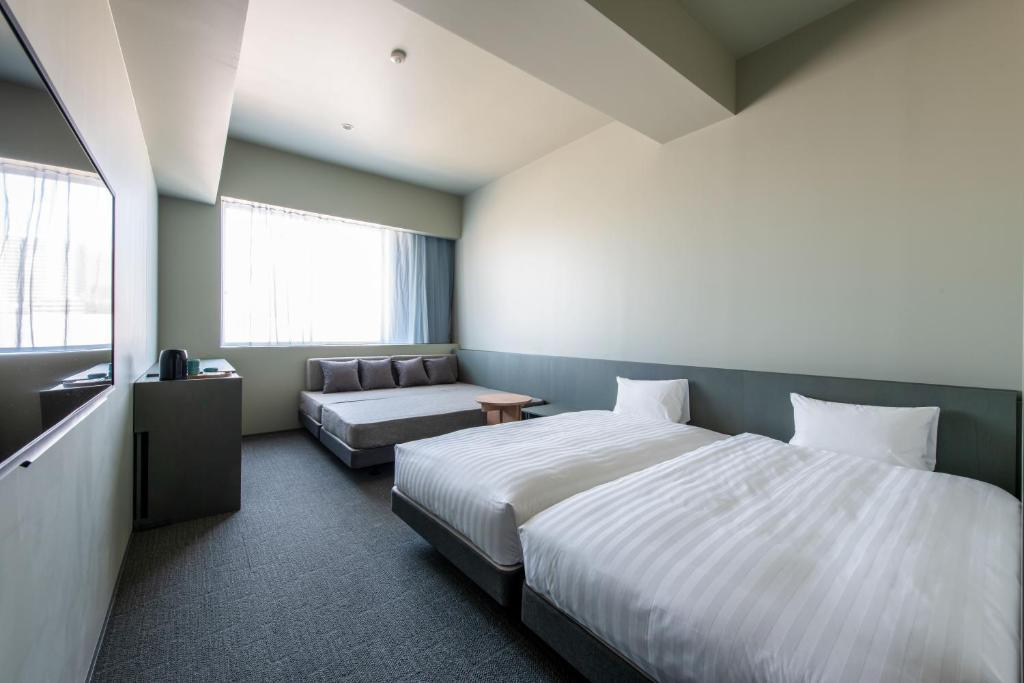 Postel nebo postele na pokoji v ubytování KAIKA Tokyo by THE SHARE HOTELS
