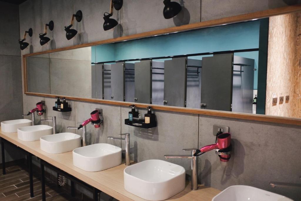 花蓮市的住宿－KID花蓮背包客棧，一间带四个盥洗盆和大镜子的浴室