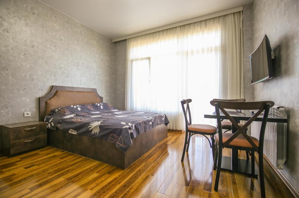 Llit o llits en una habitació de Мини - ГОСТИНИЦА "ЛЮБИМЫЙ ДОМ"